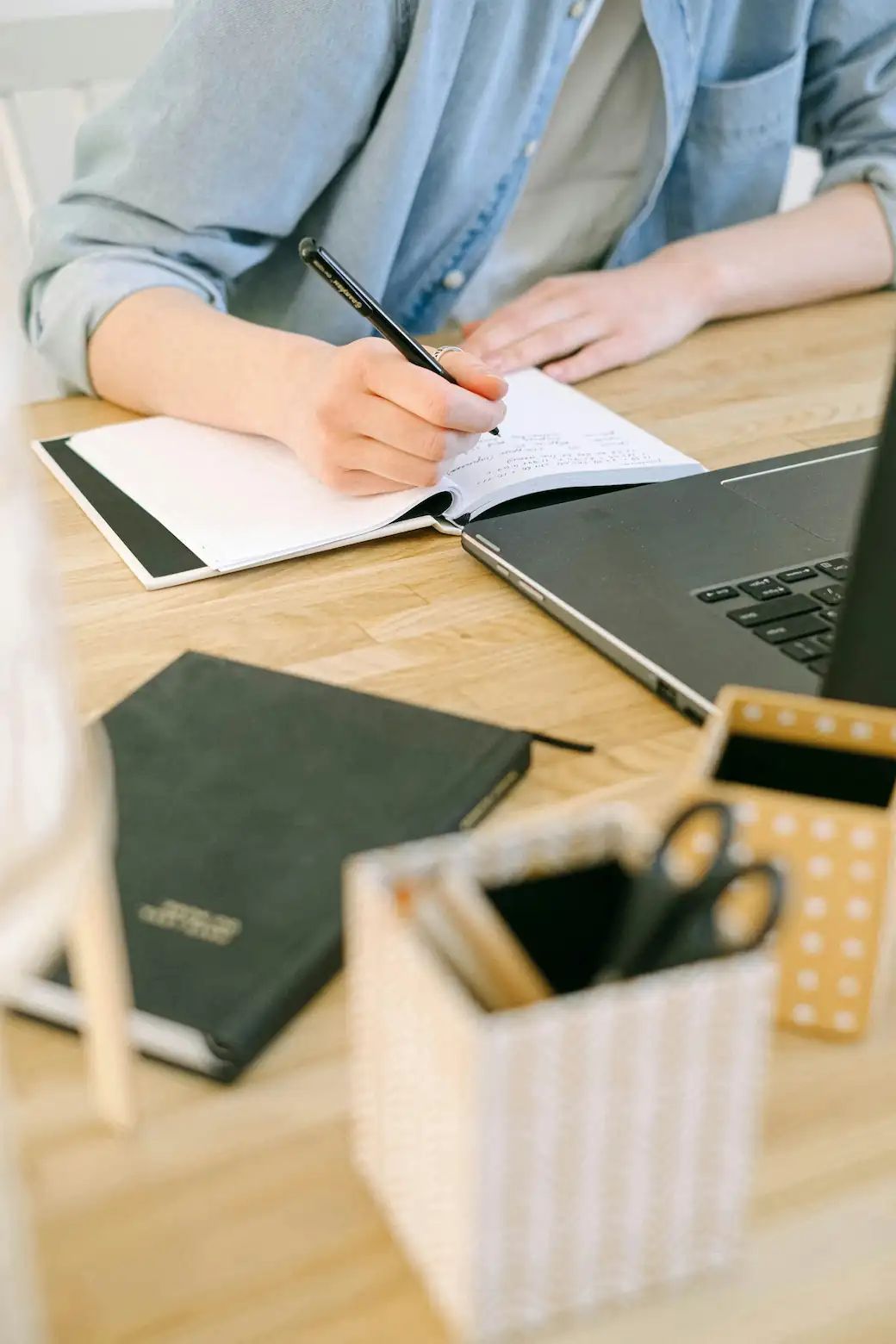 Notes. Photo by Ivan Samkov: https://www.pexels.com/photo/person-writing-on-a-notebook-4240497/